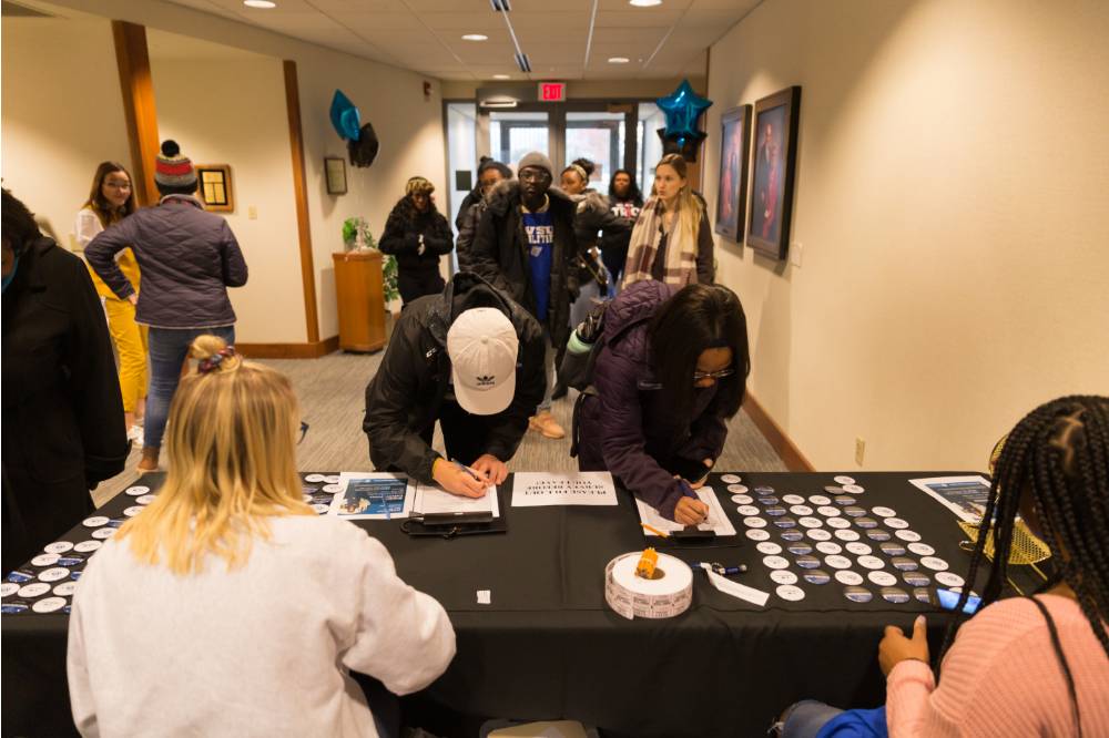 Image of students signing in to  National First Gen Day event